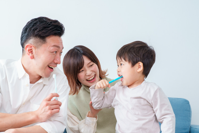 child and parents doing oral motor exercises